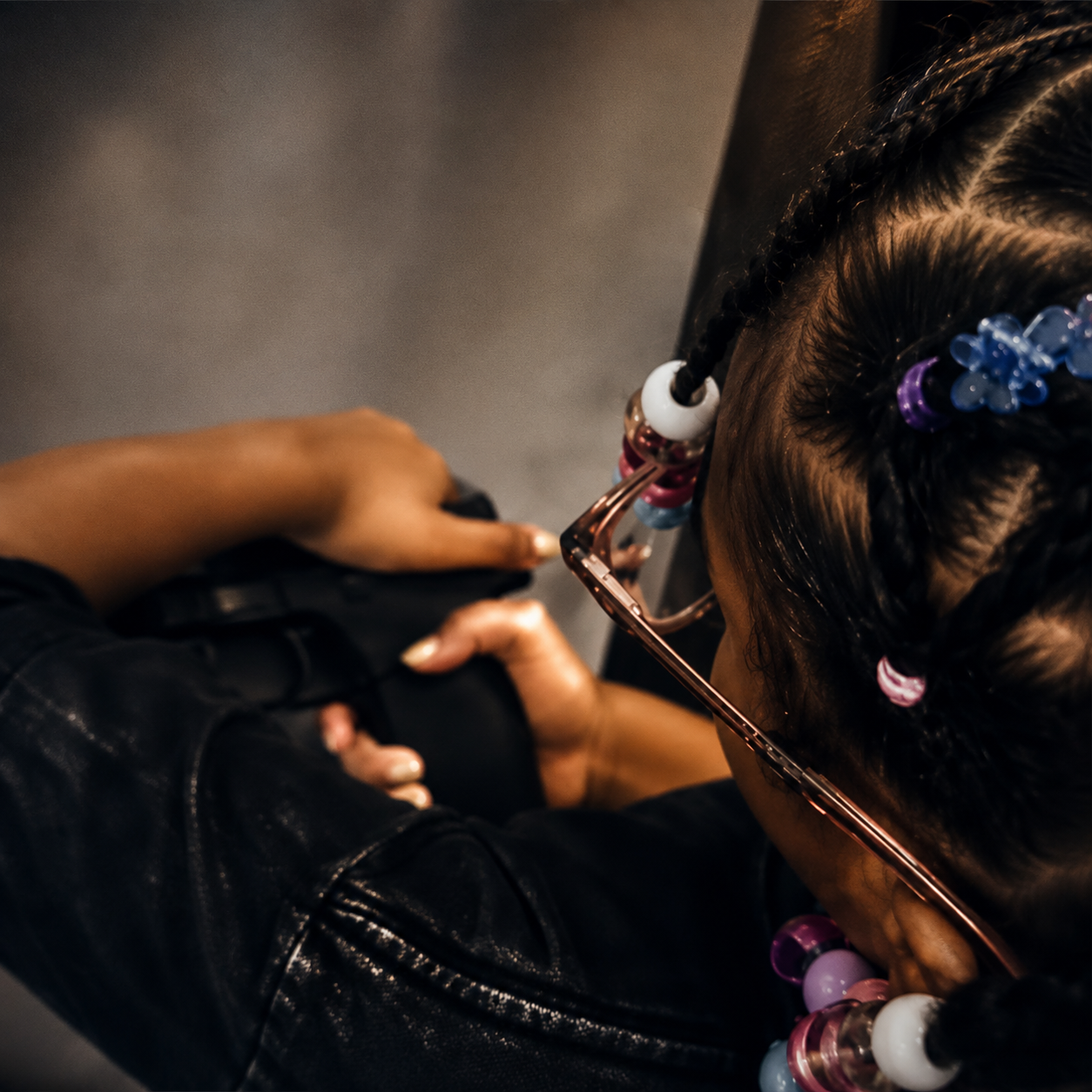 A young student learning safe handgun handling under supervision at the range